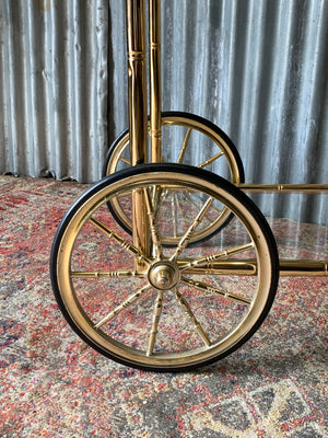 A faux bamboo Hollywood Regency two tier trolley