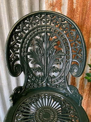 A green garden table and chairs set