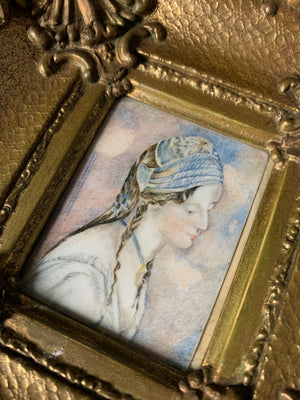 A framed miniature of a woman in blue ~ side profile