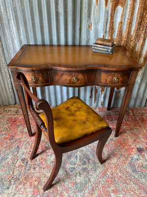 A serpentine desk and leather chair by Bevan Funnell