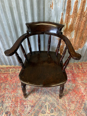 A dark wood captain's chair