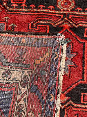 A Turkish red ground rug ~ 211cm x 138cm