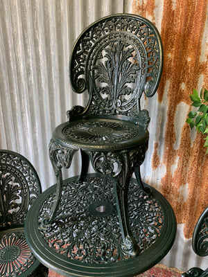 A green garden table and chairs set