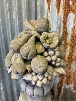 A cast stone cornucopia on plinth