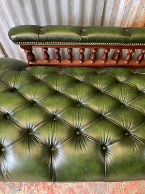 A Victorian-style green leather chaise longue