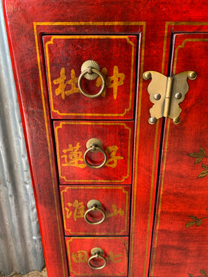 A red and gold lacquered chinoiserie cabinet