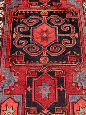 A Turkish red ground rug ~ 211cm x 138cm