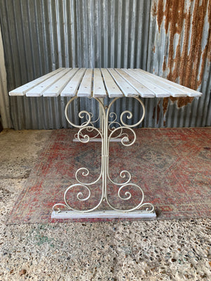 A white garden table and chairs set
