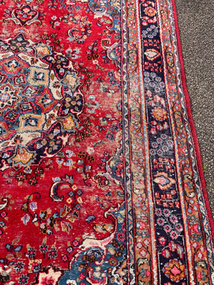 A large red ground Persian rug - 299cm x 194cm