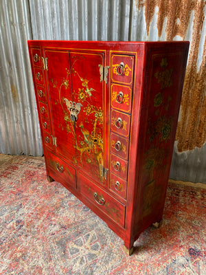 A red and gold lacquered chinoiserie cabinet