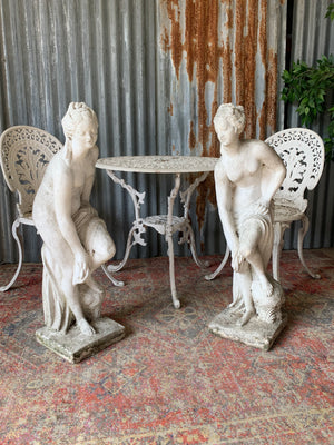 A pair of cast stone Pandora statues