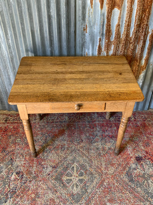 A Victorian oak table with single drawer