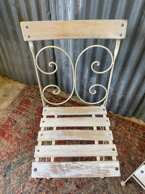 A white garden table and chairs set