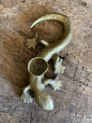 A pair of brass candlesticks in the form of lizards