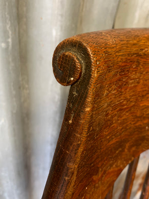 A banker's chair with caned seat