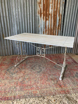 A white garden table and chairs set