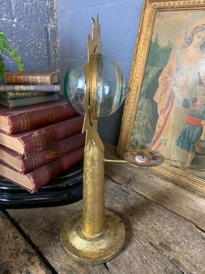 A gilt refraction candlestick with sunburst detail