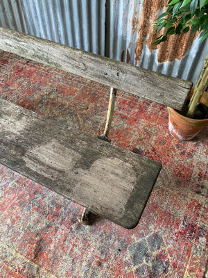 A cast iron and wooden garden bench