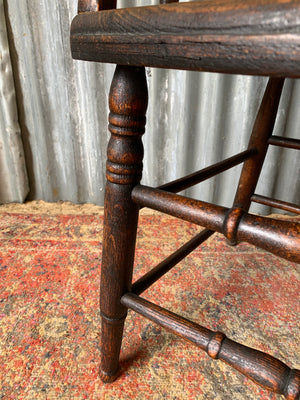 An oak spindle back captain's chair