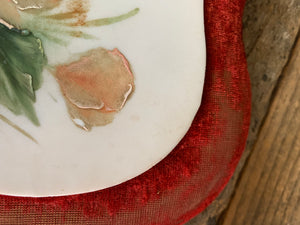 A pair of Victorian porcelain heart plaques on red velvet mounts