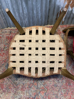 A pair of red damask giltwood open armchairs