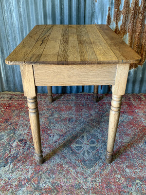 A Victorian oak table with single drawer