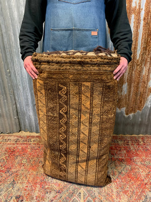 A large golden Persian carpet cushion