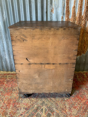 A pine chest of six drawers on castors