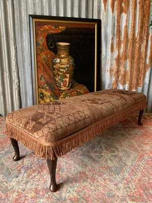 A large Persian carpet footstool