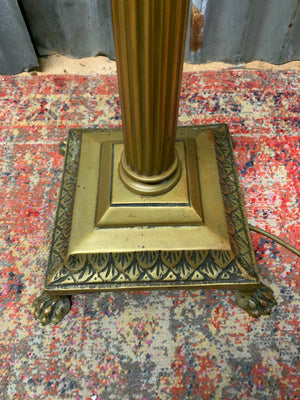 A brass Corinthian column standard lamp on lion paw feet