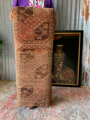 A large Persian carpet footstool