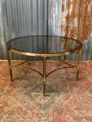 A rare circular brass and glass Hollywood Regency coffee table