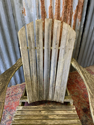 A wooden Adirondack chair and ottoman