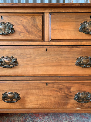 An Art Nouveau chest of drawers