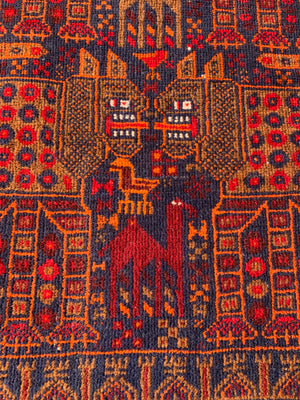 A rectangular red ground Belouch Herat rug depicting lions, camels and birds