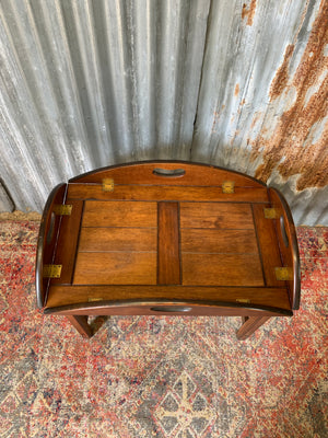 A mahogany butler's tray table