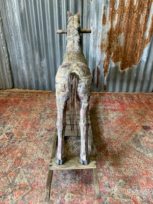 Carved wooden rocking horse