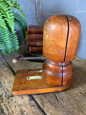 A wooden millinery hat stretcher