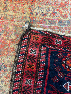 A Persian red & blue ground rectangular rug ~ 179cm x 96cm