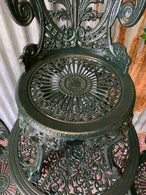 A green garden table and chairs set