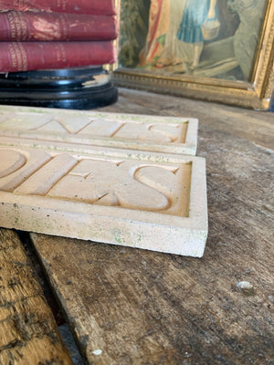 A pair of cast stone plaques ~ "LADIES" & "GENTS"