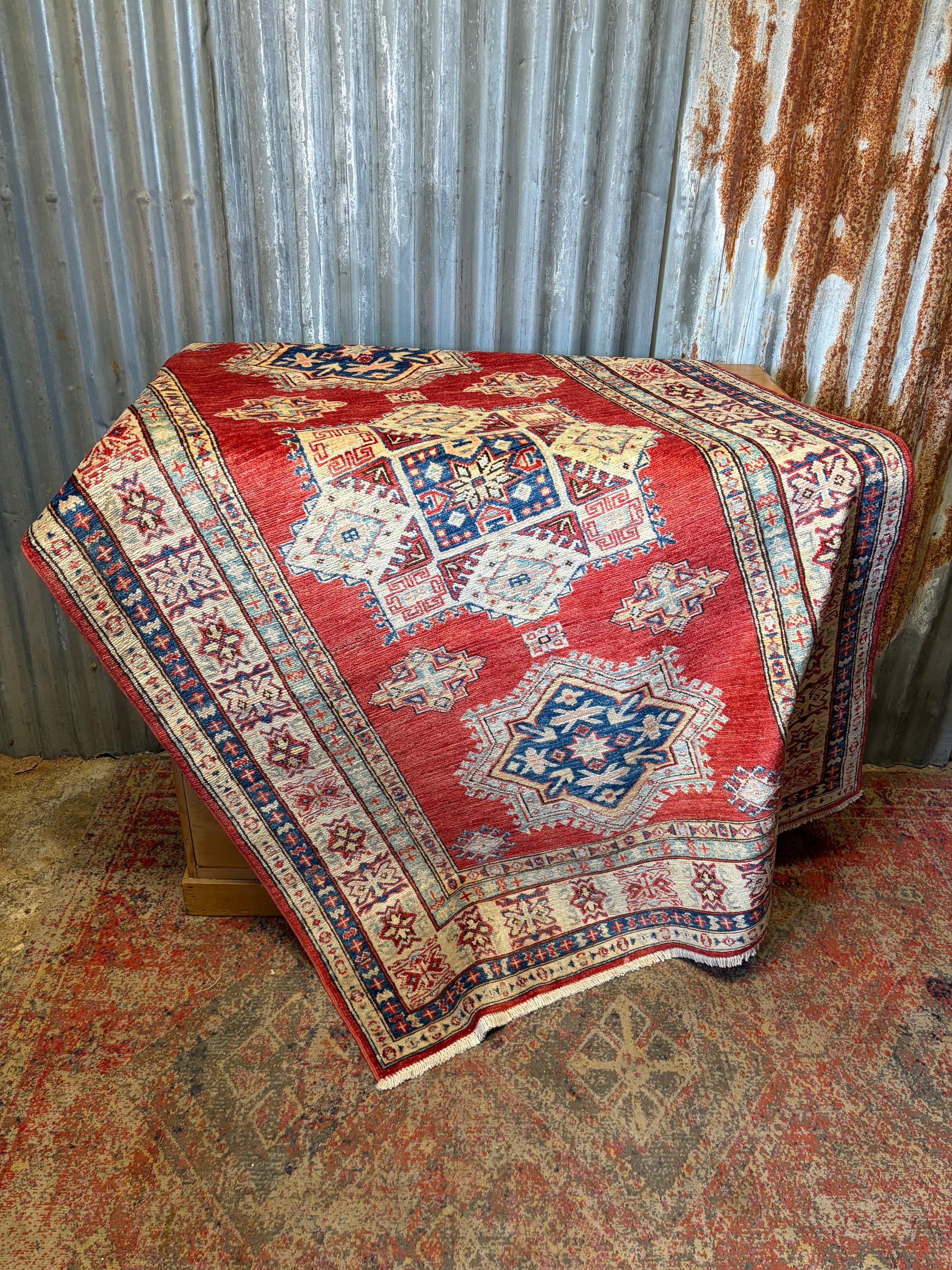 A russet ground Kazak carpet rug ~ 197cm x 125cm