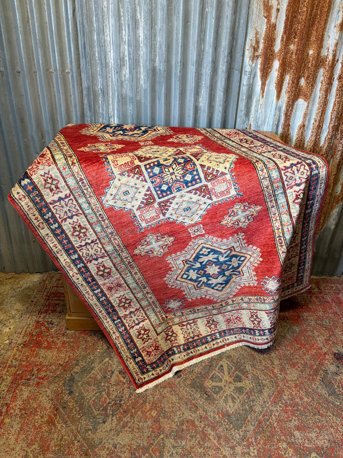 A russet ground Kazak carpet rug ~ 197cm x 125cm