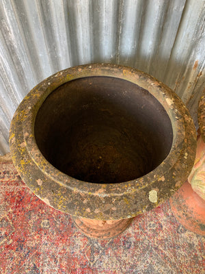 A pair of large terracotta acanthus urns