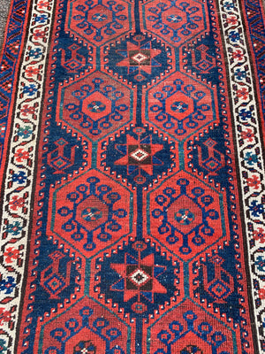 A long red ground blue Persian runner rug ~ 304cm x 104cm