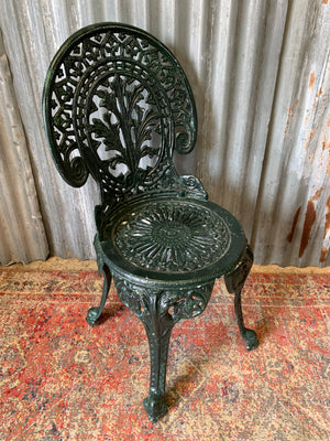 A green garden table and chairs set