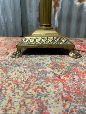 A brass Corinthian column standard lamp on lion paw feet