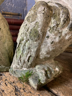 A trio of cast stone pelican statues