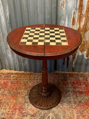 A cast iron bistro table with hand-painted chess board top