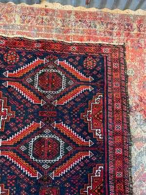 A Persian red & blue ground rectangular rug ~ 179cm x 96cm